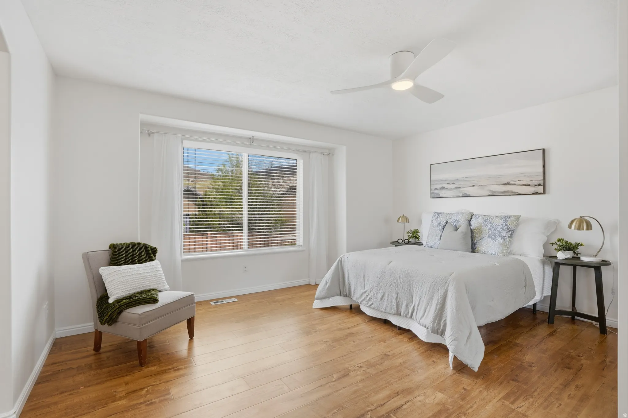 Spacious interior with wood-finish flooring and white walls