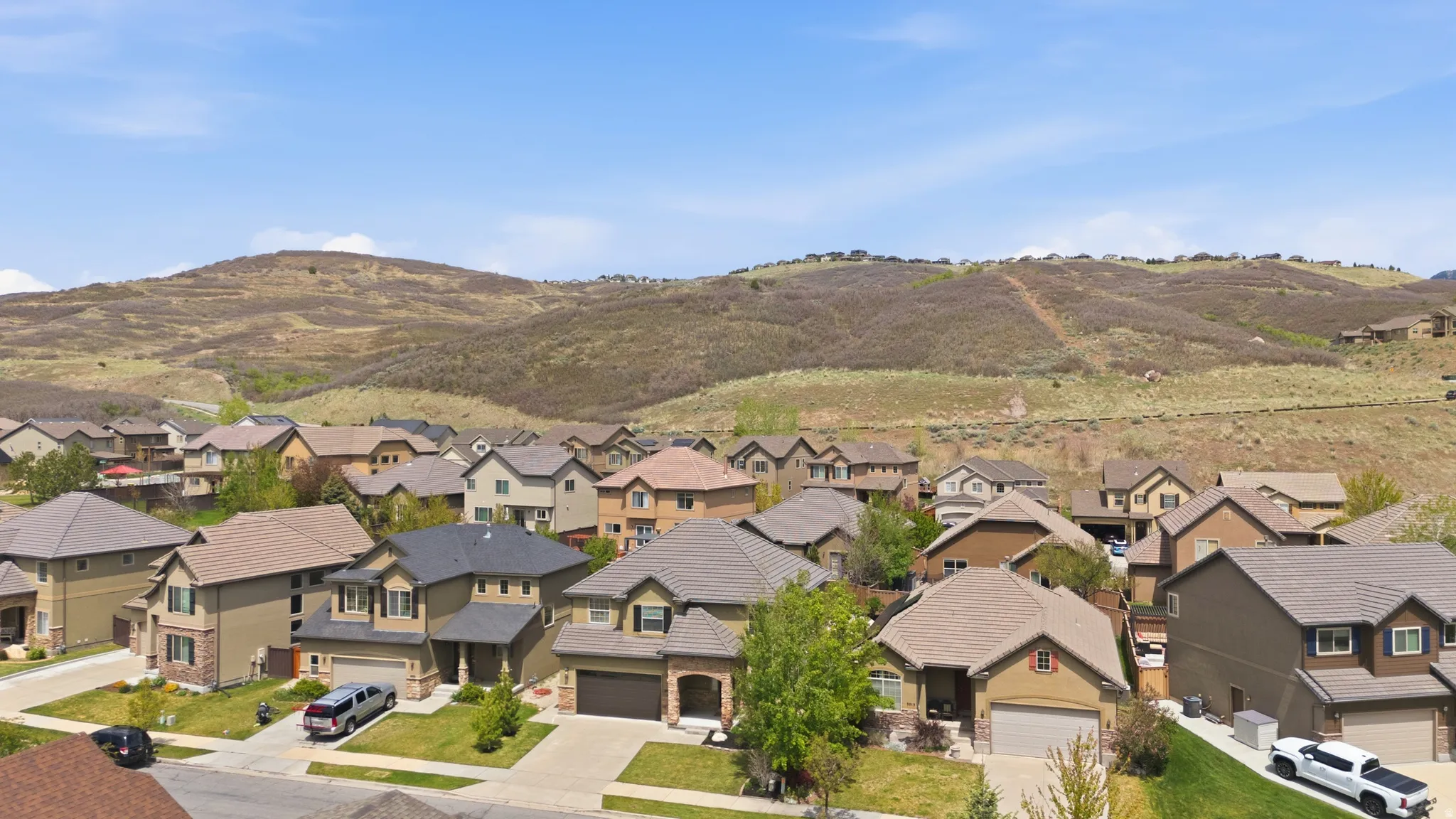 Residential community situated at the base of a verdant hillside