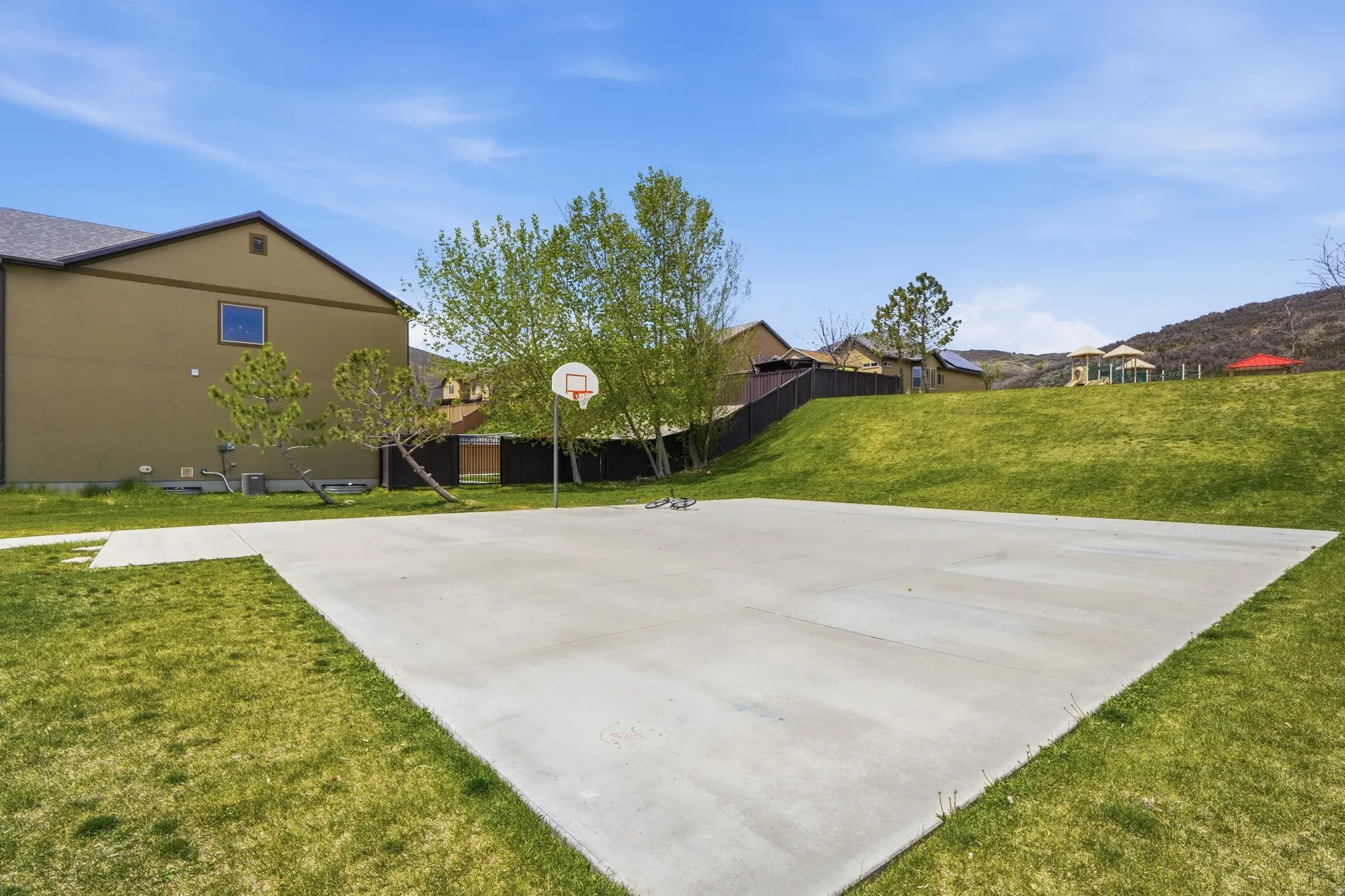 Concrete sport court with an attached basketball hoop