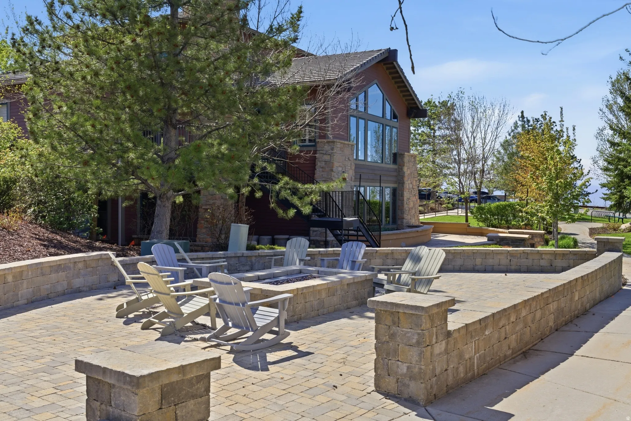Paver patio with an integrated fire pit, surrounded by low stone retaining walls