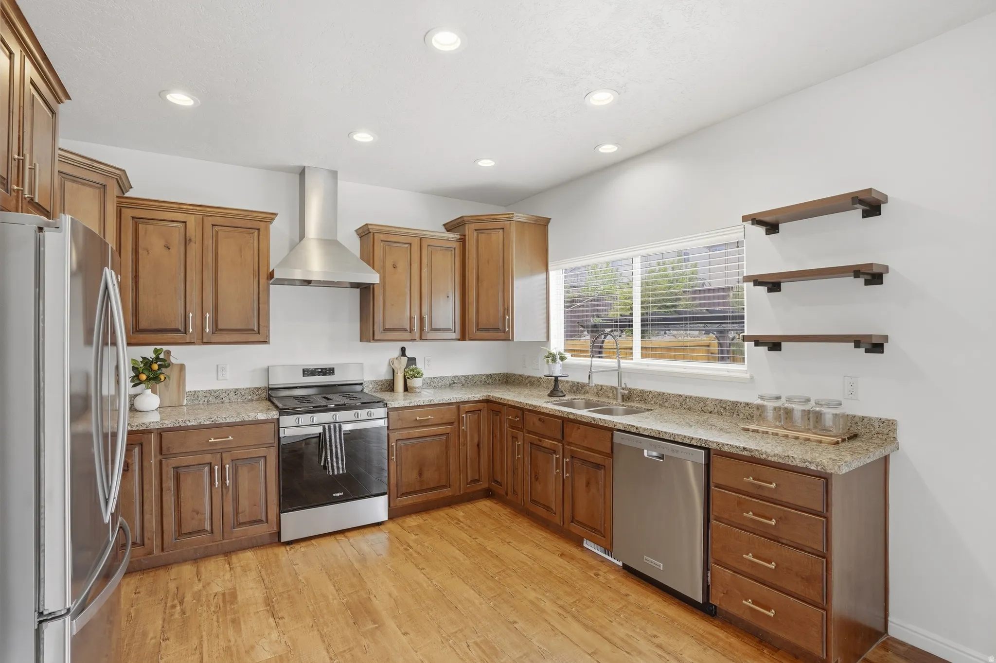Kitchen featuring wood-finish flooring, recessed lighting, and a stainless steel appliance suite