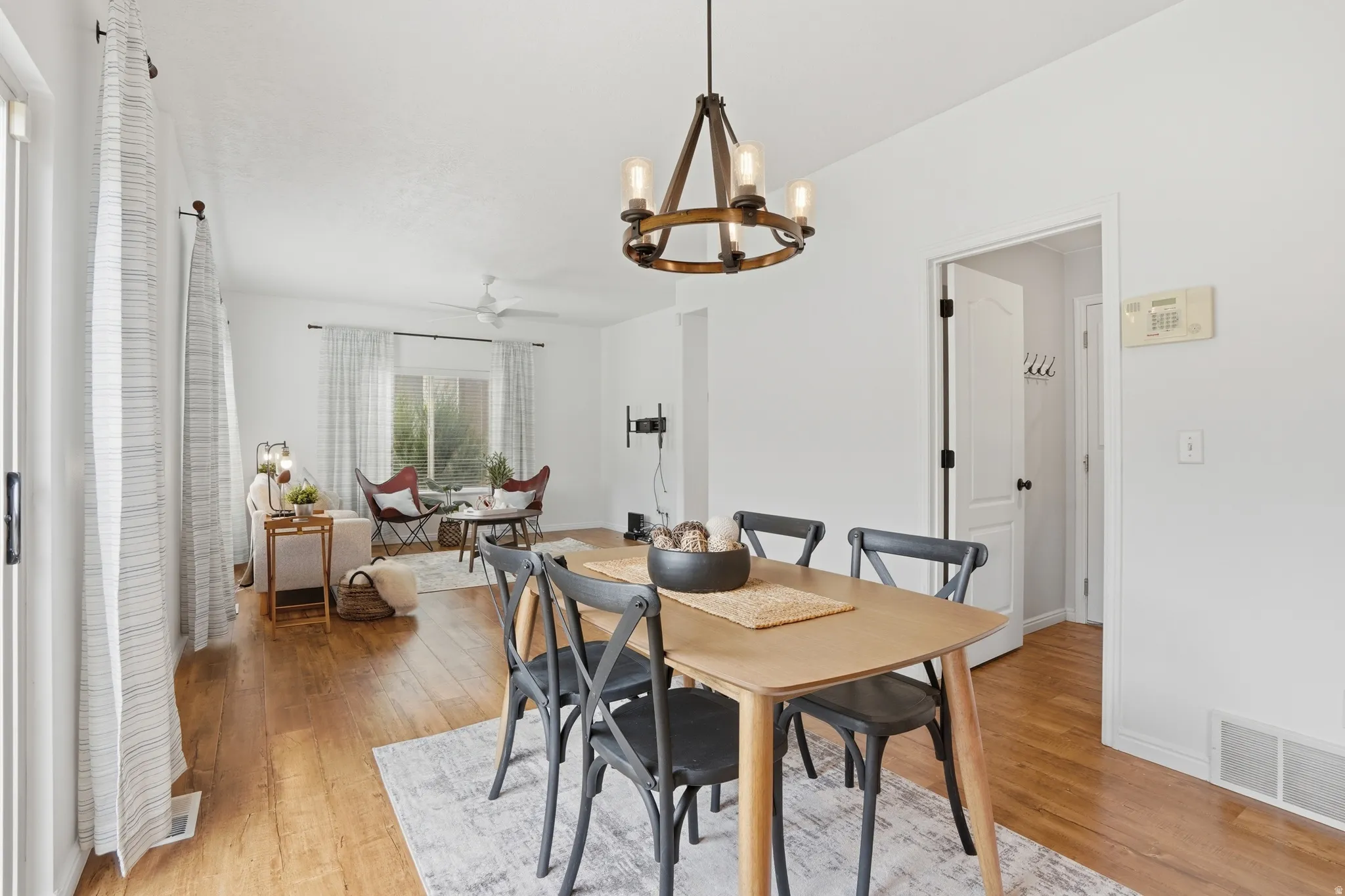 Dining area featuring a contemporary chandelier and wood-finish flooring
