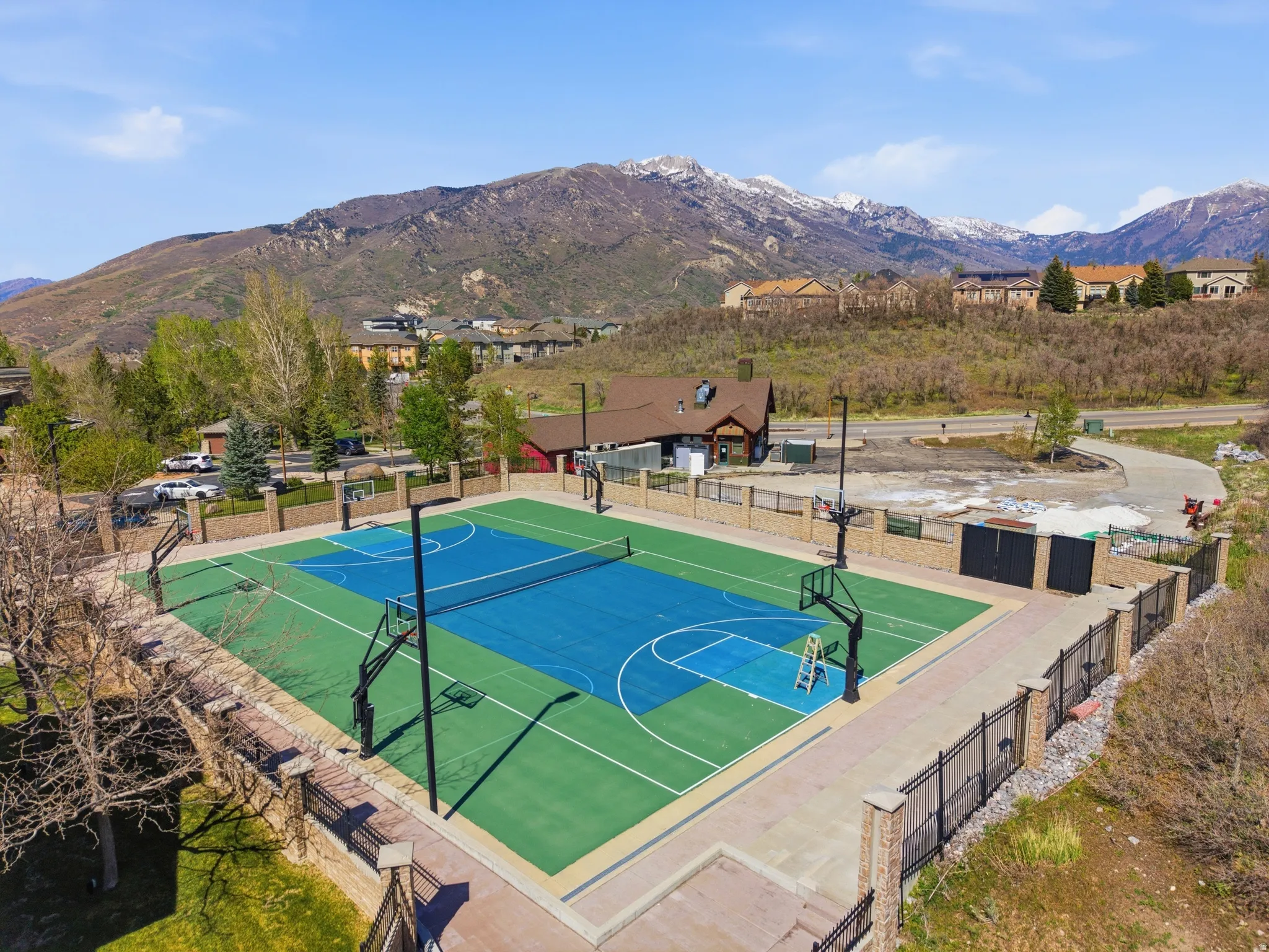Multi-sport court featuring vibrant blue and green surfacing