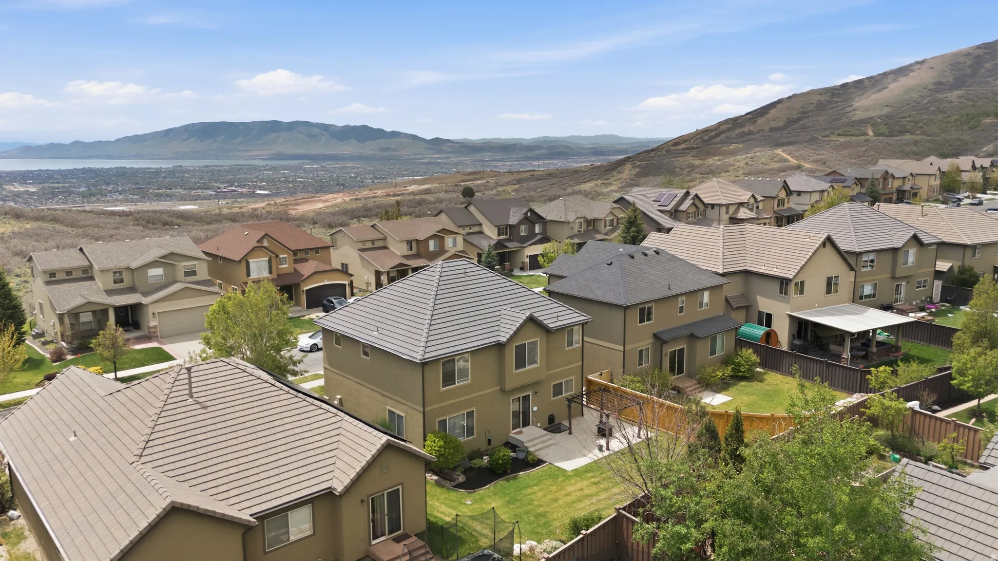 Expansive elevated neighborhood featuring a range of single-family residences with tile roofs and stucco exteriors