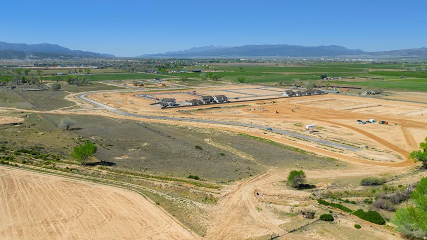 Expansive development land featuring graded lots and new construction homes