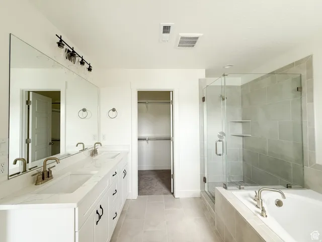 Spacious bathroom featuring a double vanity with white cabinetry and light-toned countertops