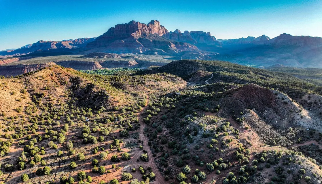 Expansive desert landscape featuring rugged terrain and distant mountain ranges