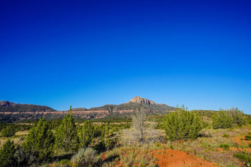 Expansive natural landscape featuring distant mountain ranges and varied terrain