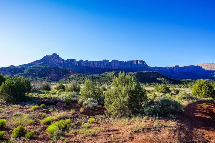 Expansive mountain backdrop with a clear blue sky