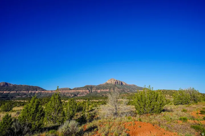 Expansive natural landscape featuring distant mountain ranges and varied terrain