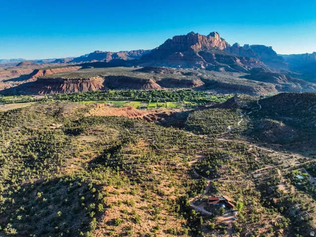 Expansive desert landscape featuring a prominent mountain range backdrop