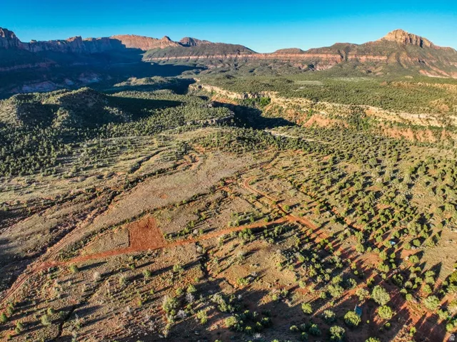 Expansive desert landscape featuring rugged mountain ranges in the distance