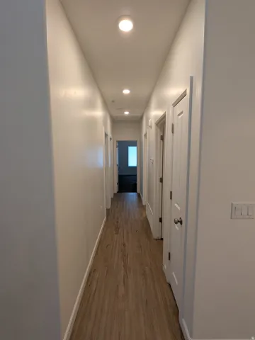 Corridor featuring dark wood-style floors and recessed lighting