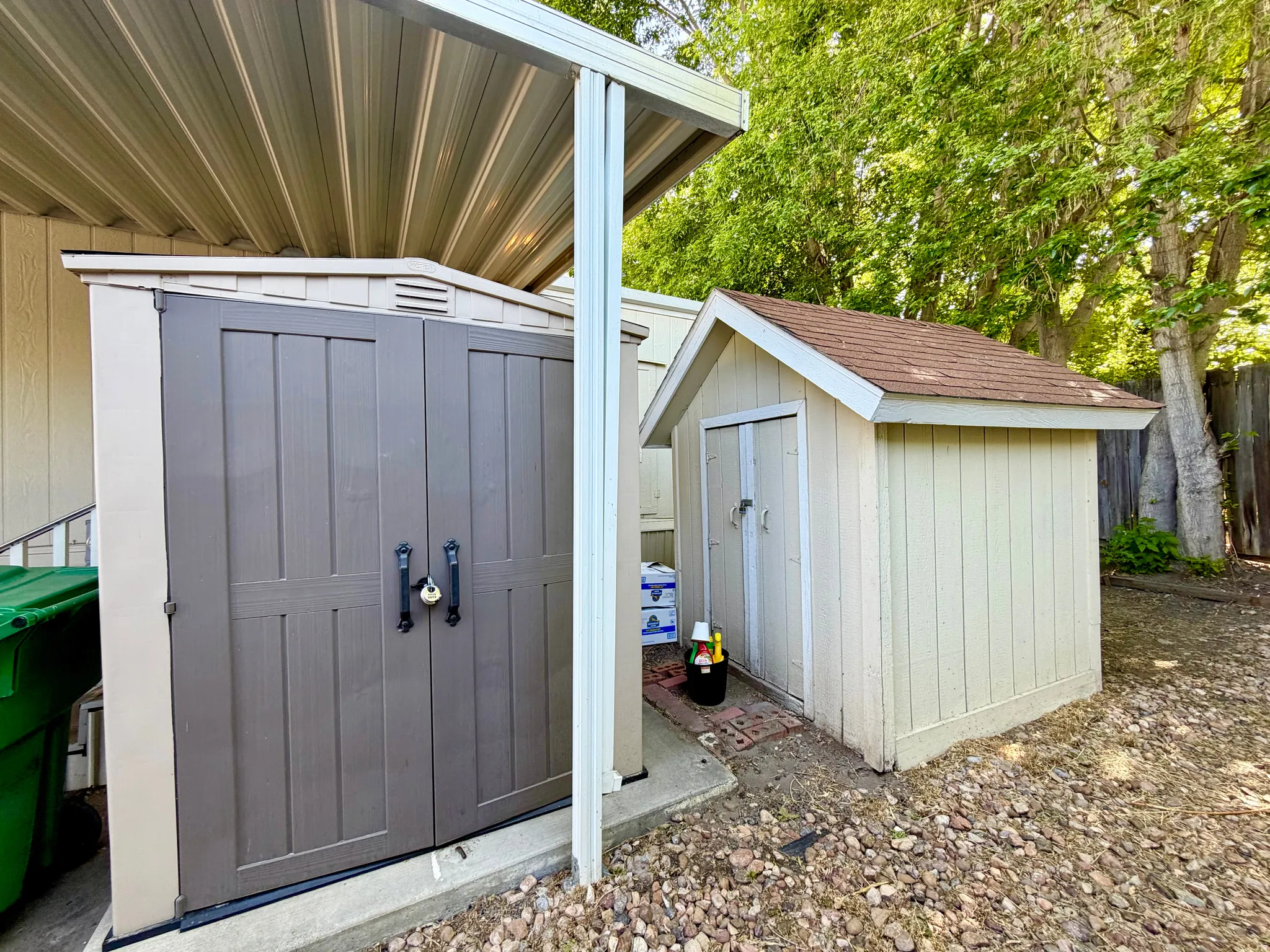 Home has 2 storage sheds at the back of the carport - by the home's side entry