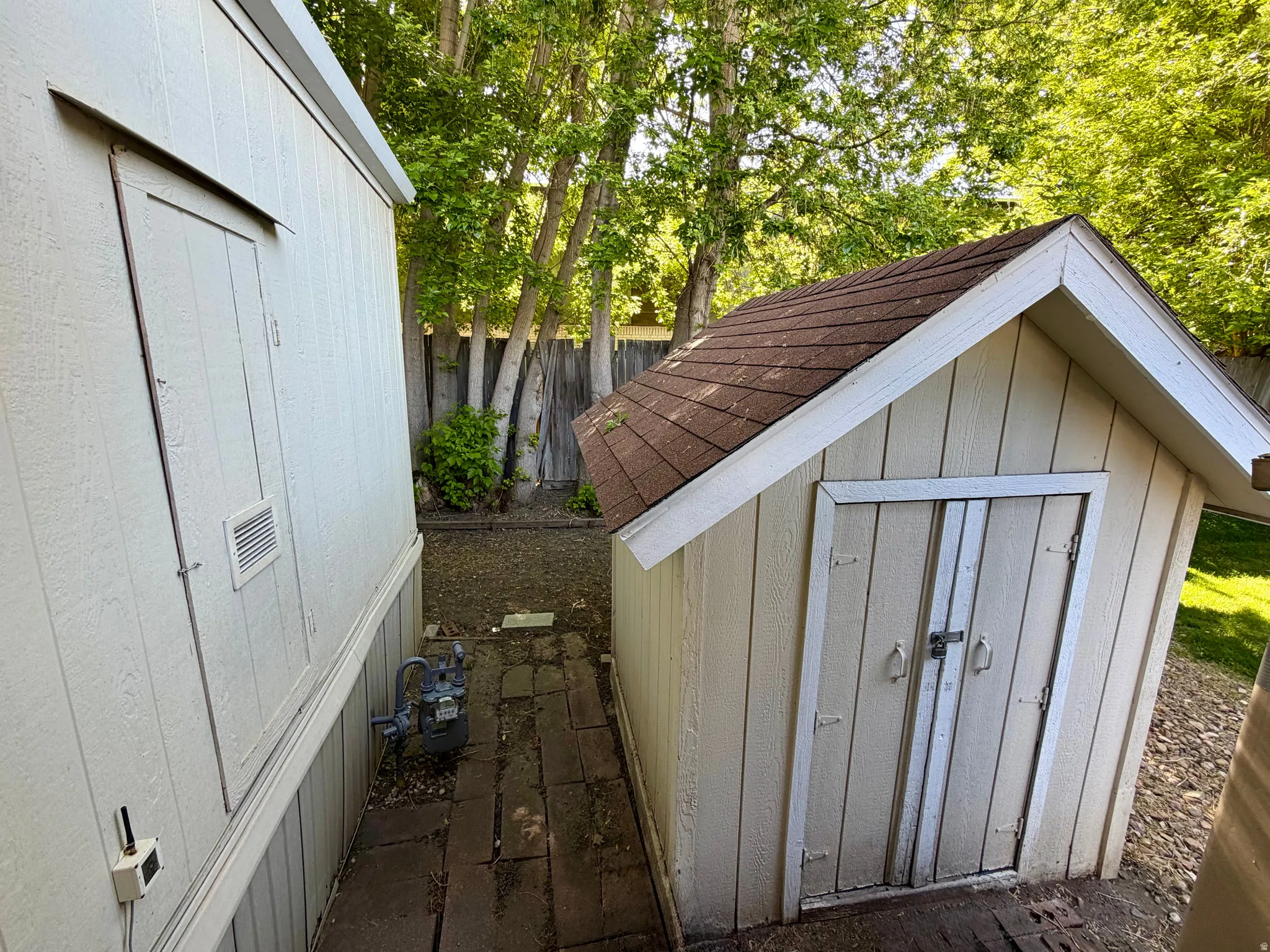 Home has 2 storage sheds at the back of the carport - by the home's side entry