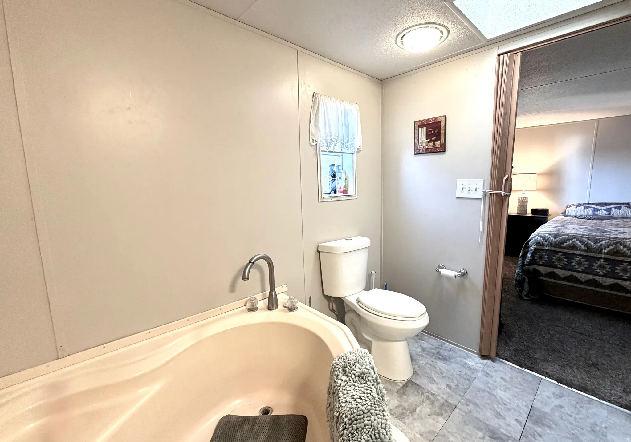 Large primary bathroom with plenty of cabinet storage, soaker tub, and separate shower