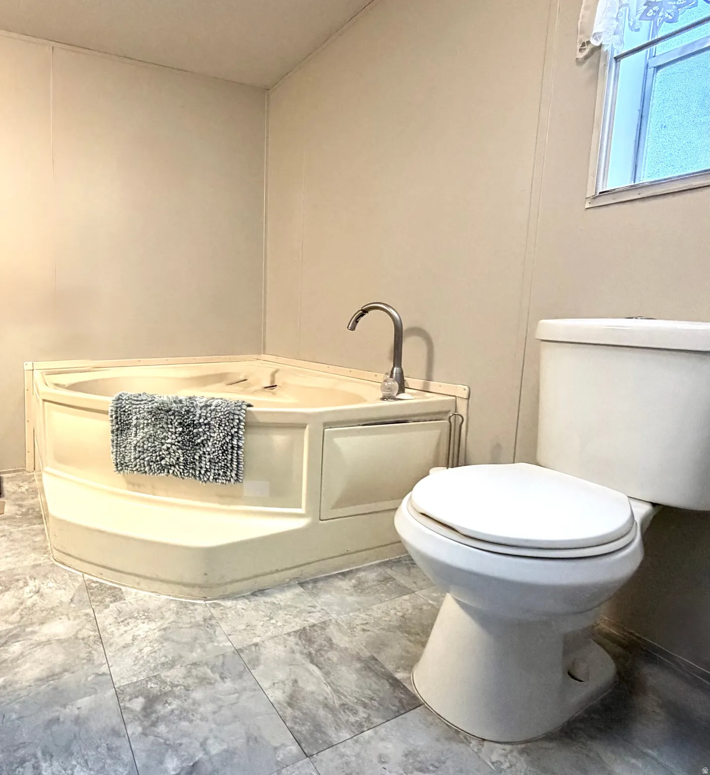 Large primary bathroom with plenty of cabinet storage, soaker tub, and separate shower