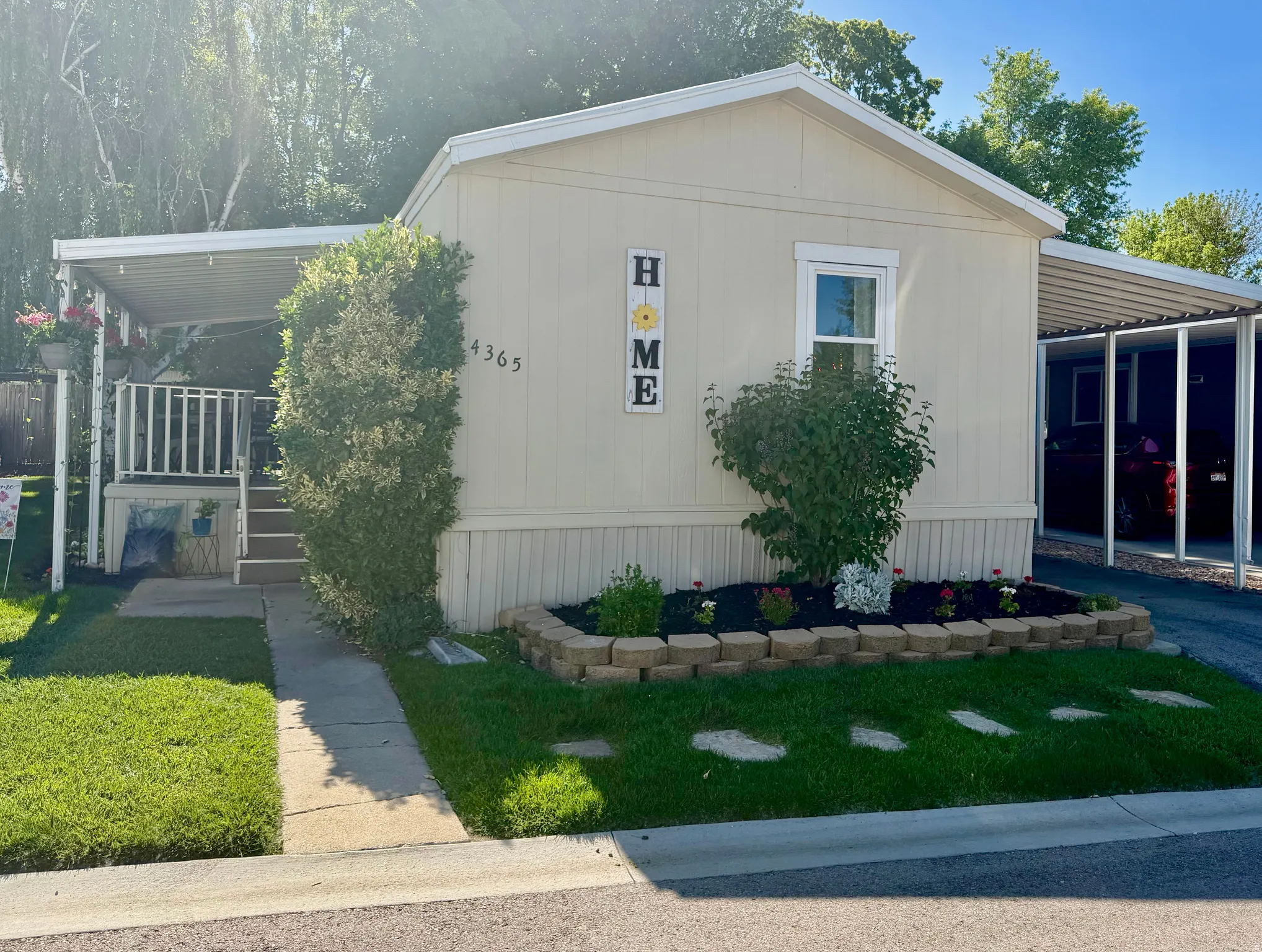 Main level living with attached carport, covered front porch, and easy to manage front yard.