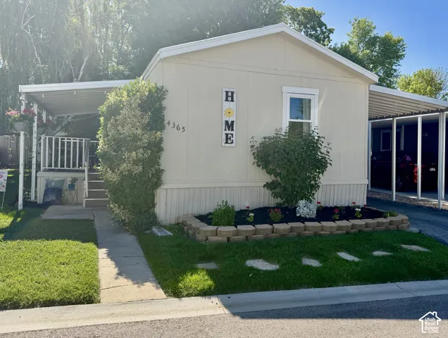 Main level living with attached carport, covered front porch, and easy to manage front yard.