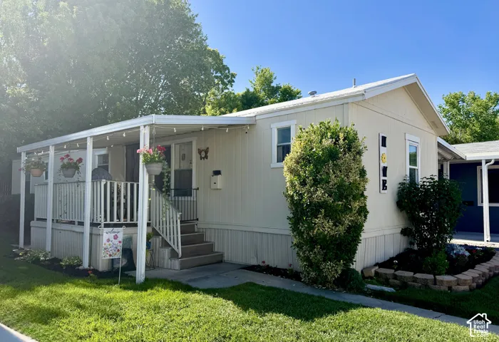 Main level living with attached carport, covered front porch, and easy to manage front yard.
