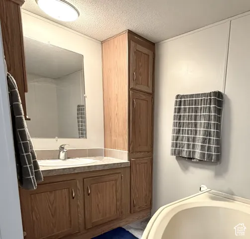 Large primary bathroom with plenty of cabinet storage, soaker tub, and separate shower