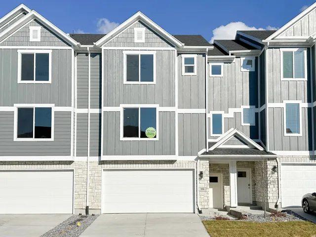 Modern townhome exterior featuring gray siding with white trim accents