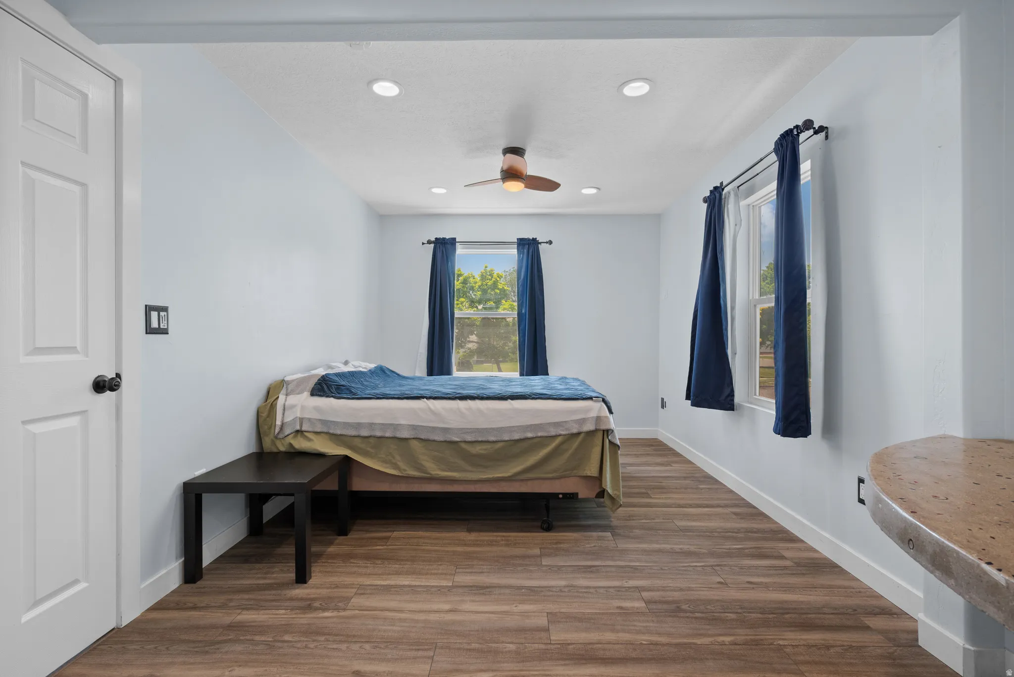 Spacious interior featuring wood-finish flooring, recessed lighting, and a ceiling fan