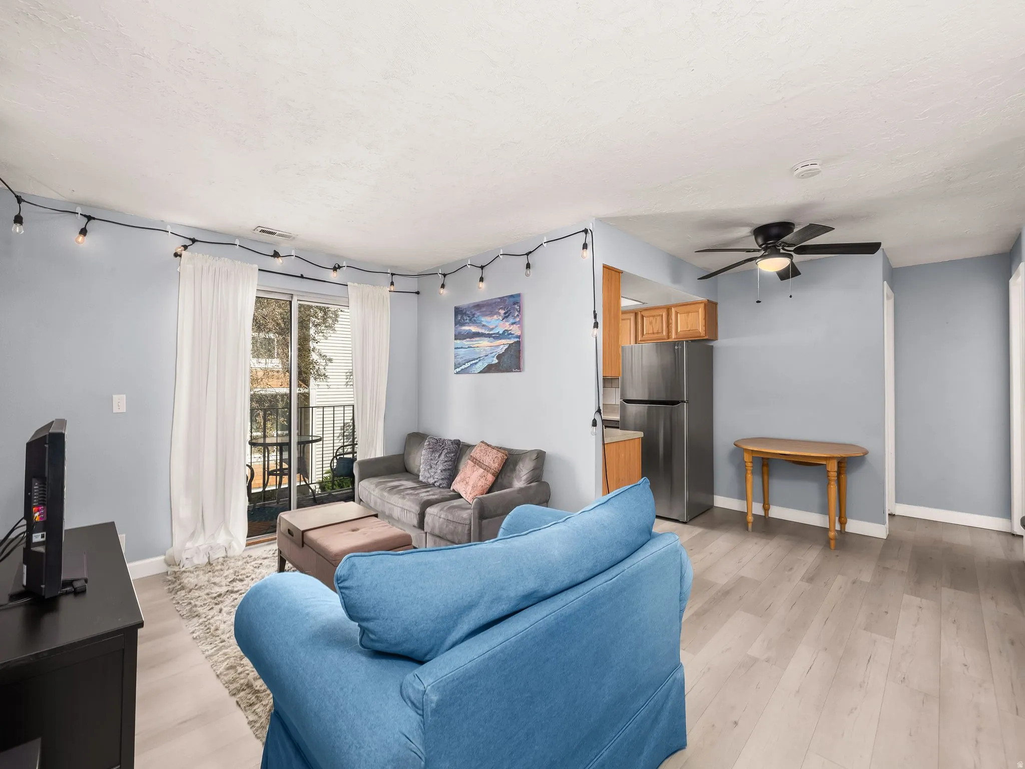 Living area featuring wood-finish flooring and light blue walls