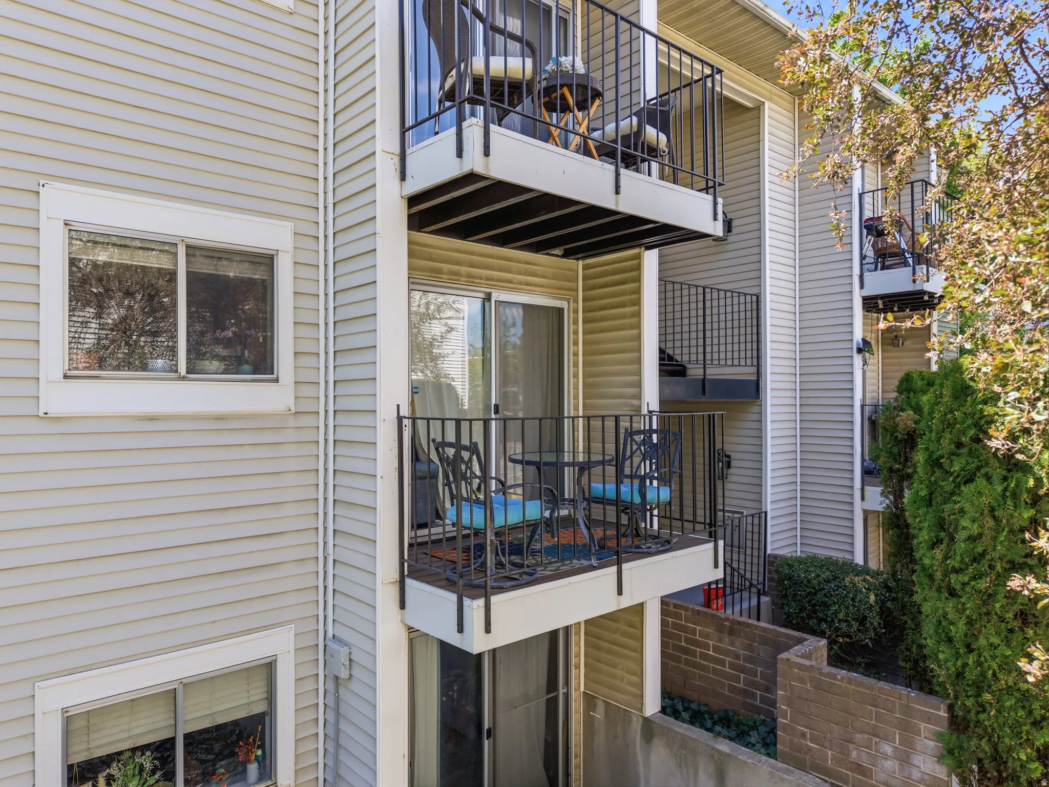 Multi-level exterior balconies with black wrought iron railings