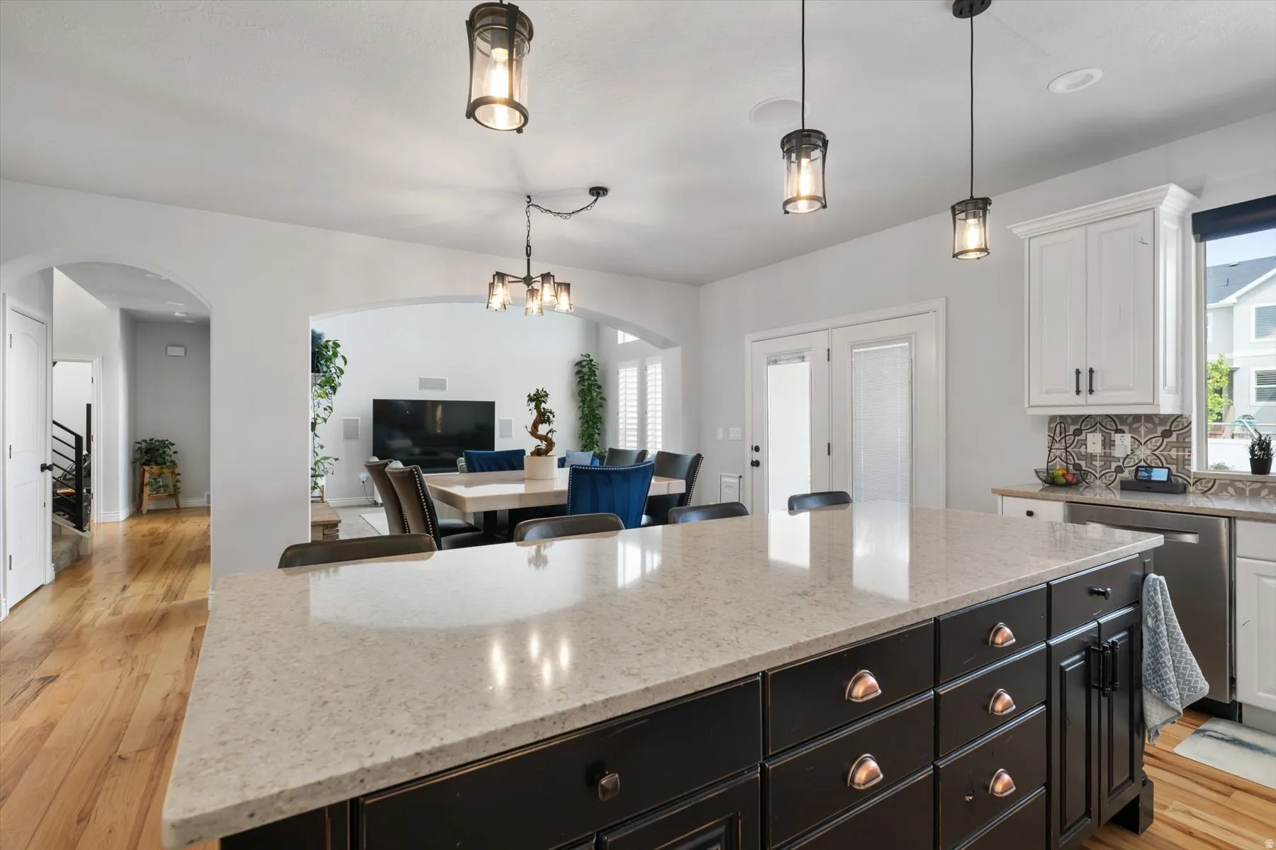 Spacious kitchen island featuring a light-toned countertop and dark wood-finish cabinetry