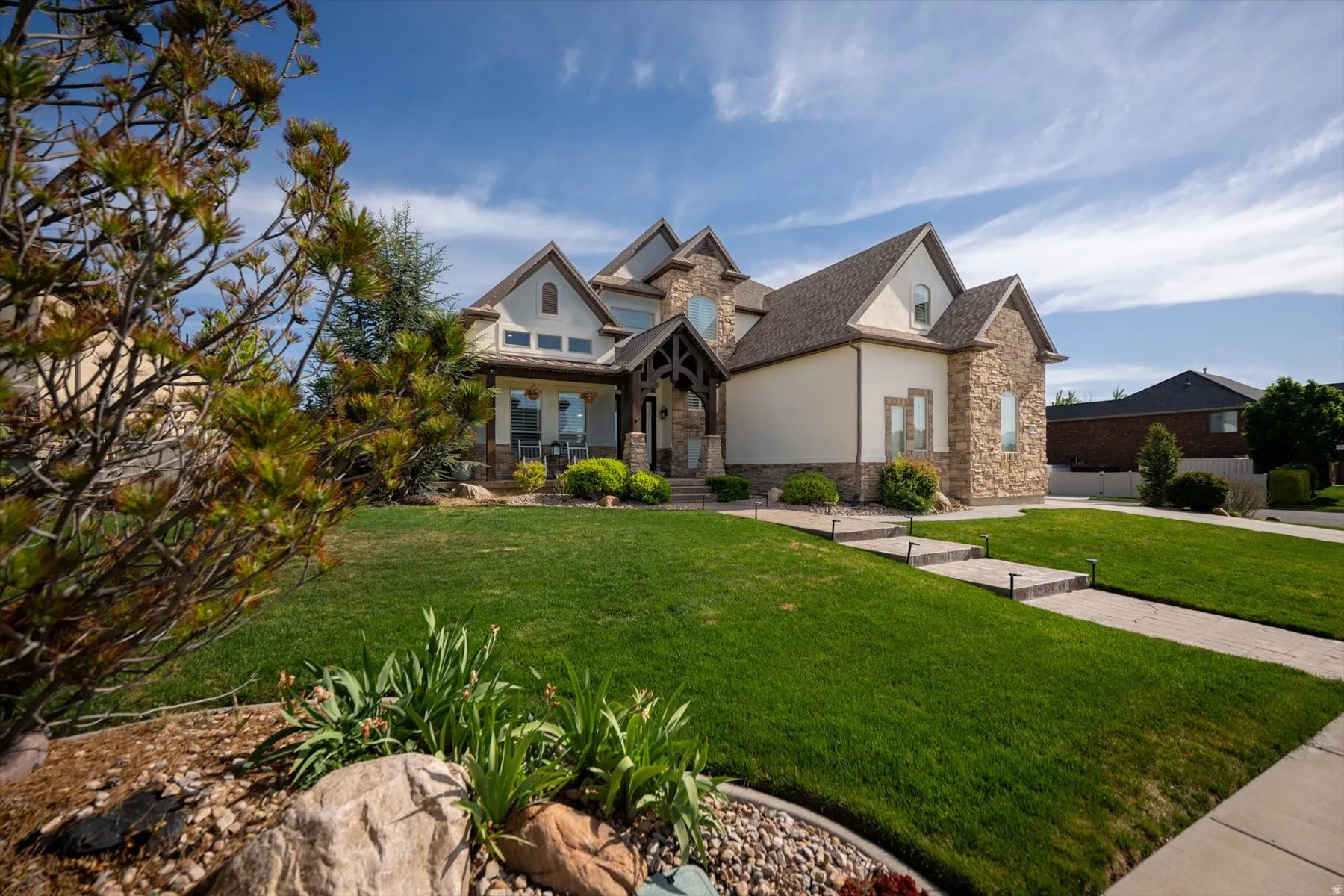 Stone and stucco exterior with gabled roof lines