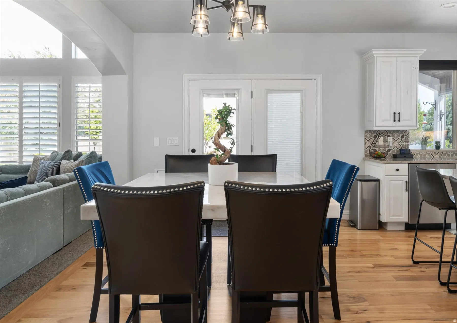 Open-concept dining area featuring a rectangular table with a light-toned surface