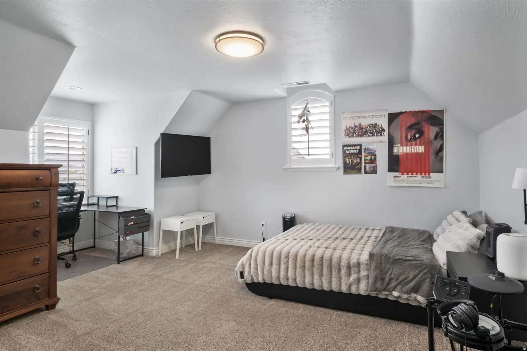 Carpeted bedroom with a ceiling-mounted light fixture