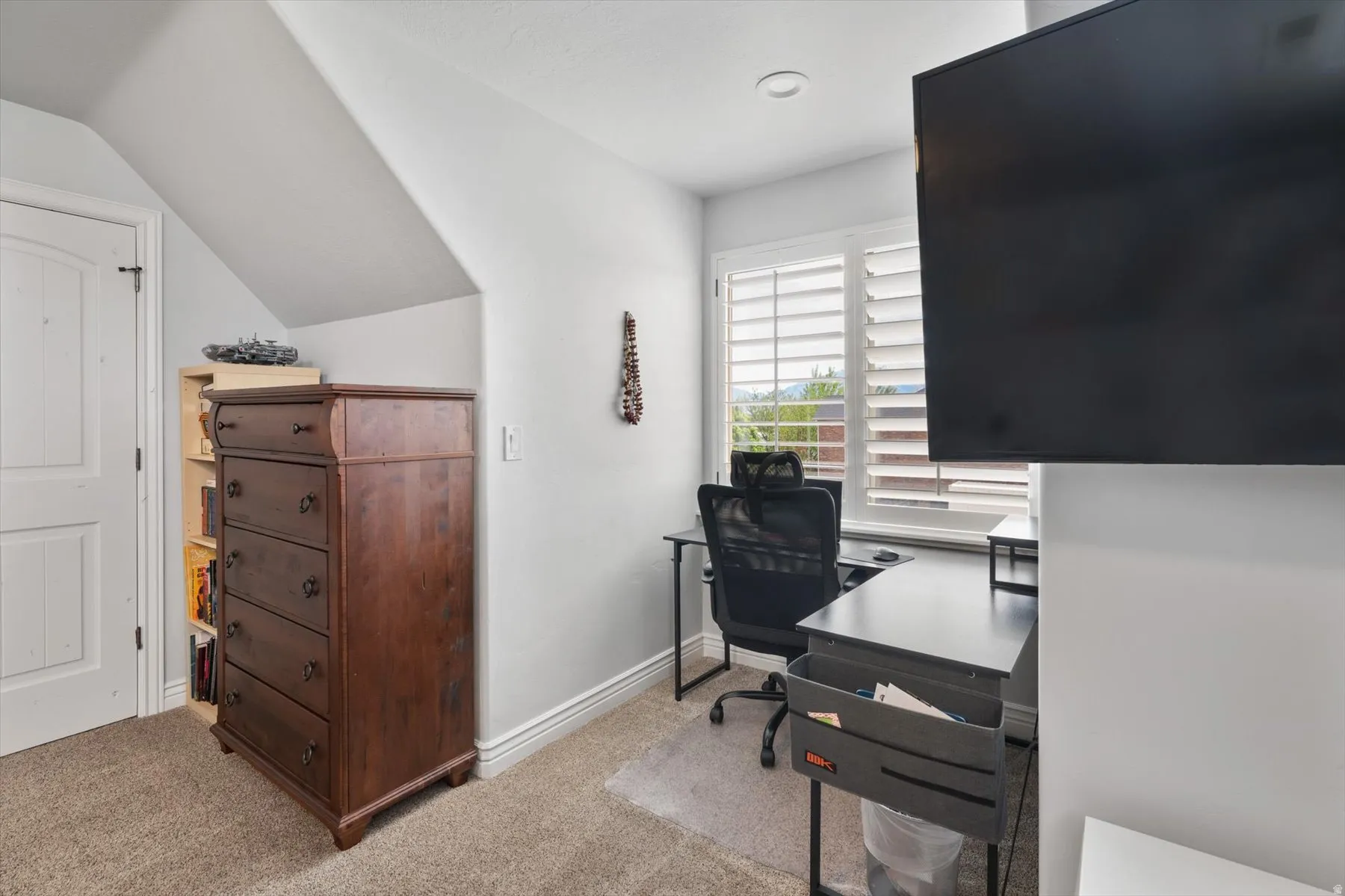 Bedroom featuring sloped ceilings and light gray walls