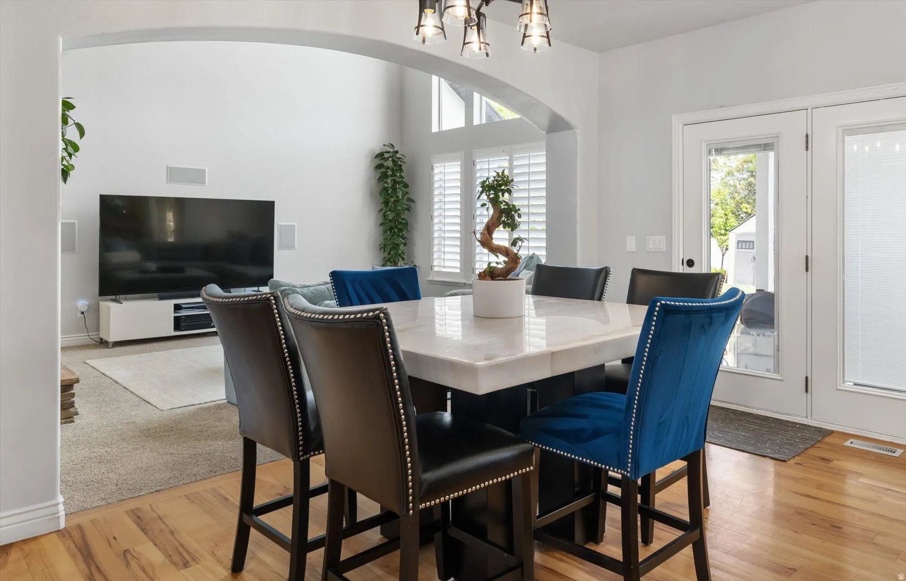 Dining area featuring  hardwood flooring, and direct outdoor access through double glass-paneled doors
