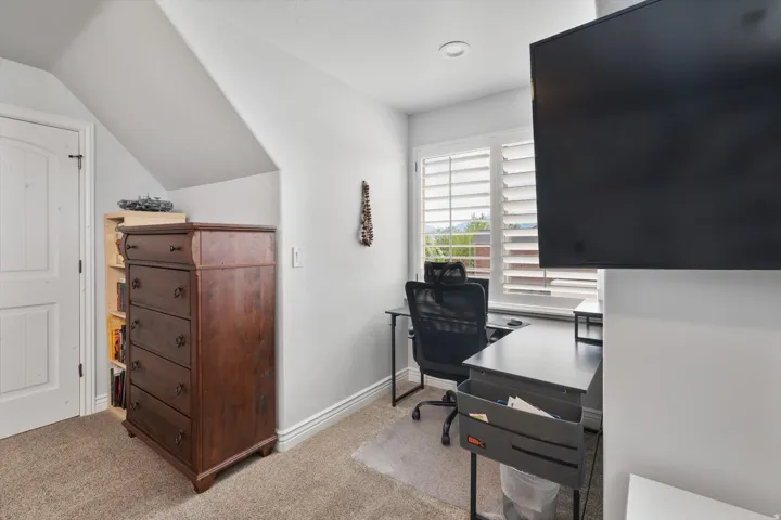 Bedroom featuring sloped ceilings and light gray walls