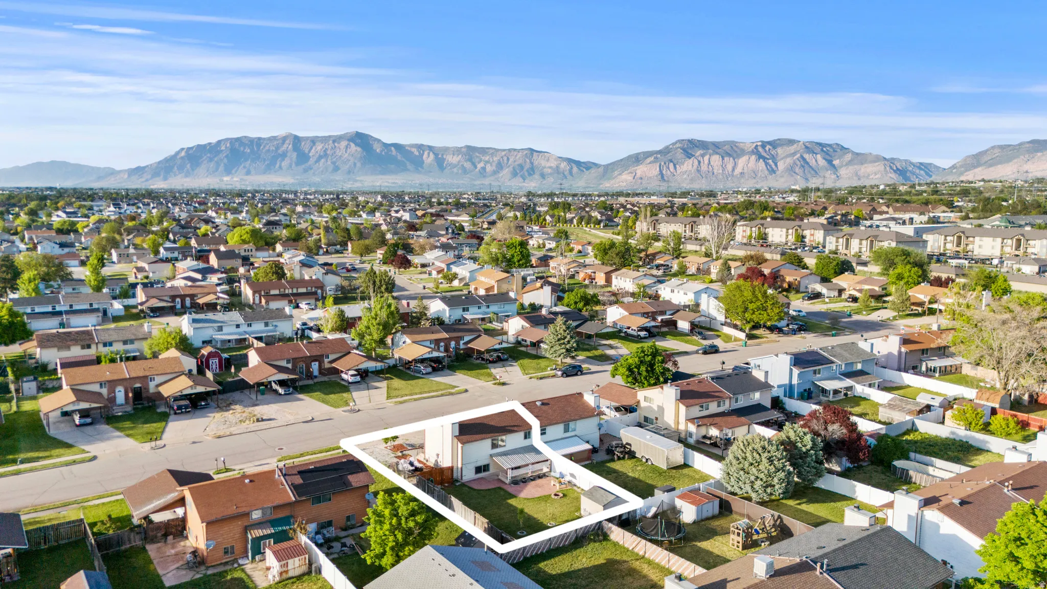 Aerial view of a residential neighborhood with a prominent mountain backdrop
