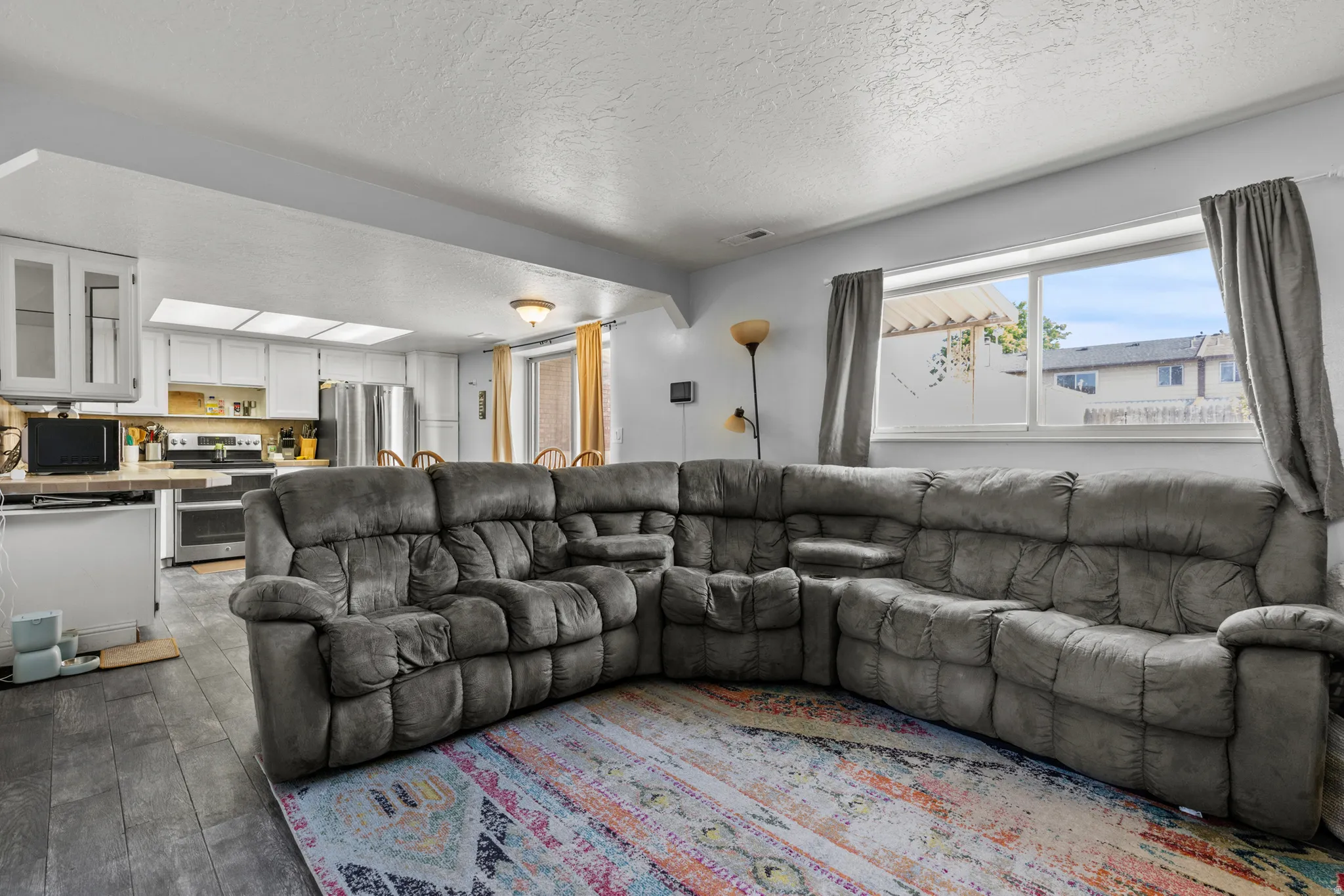 Open-concept living area featuring wood-finish flooring
