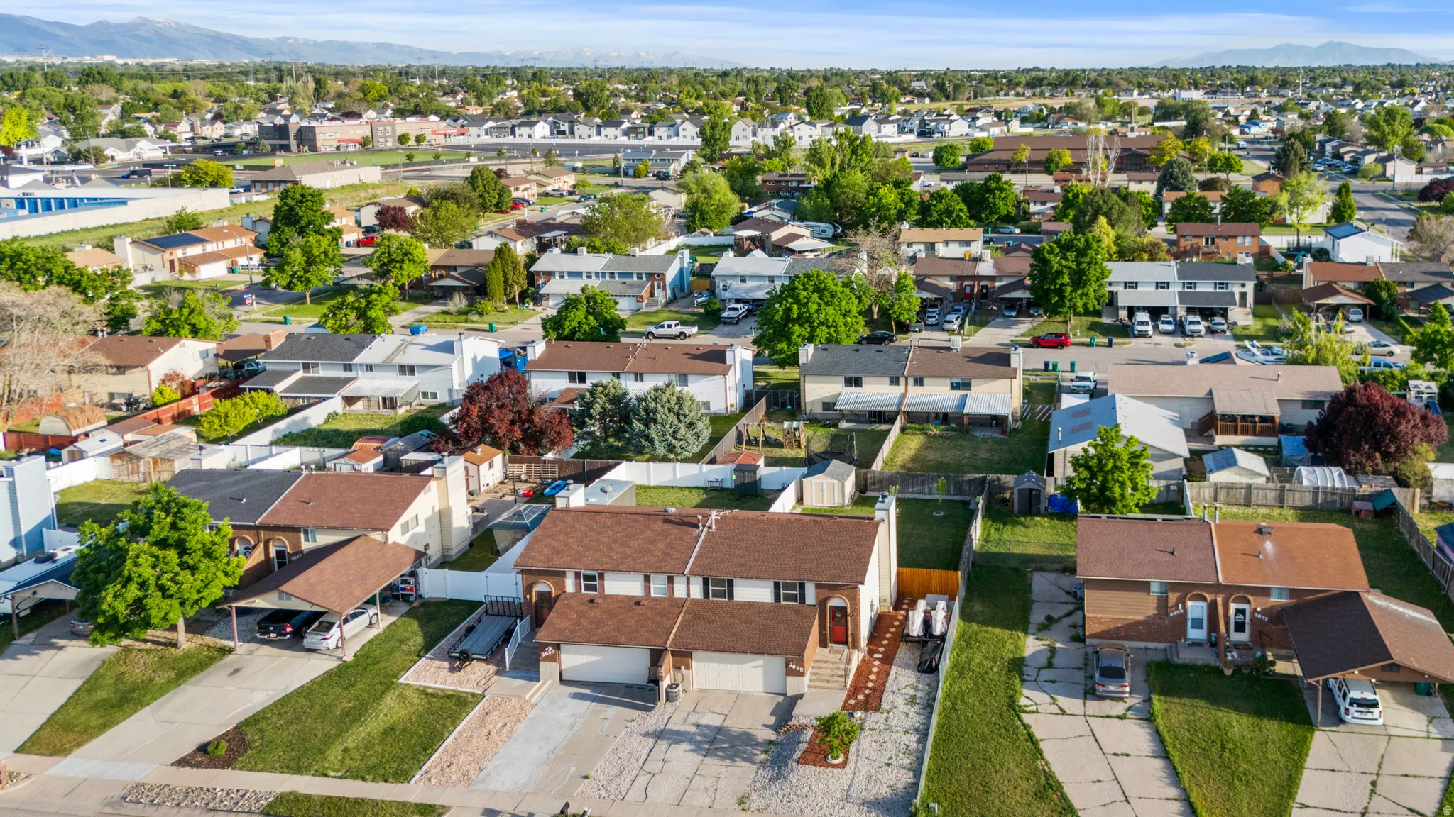 Aerial perspective showcasing a residential neighborhood with varied architectural styles and mature landscaping