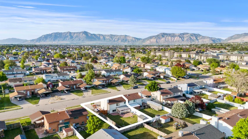 Aerial view of a residential neighborhood with a prominent mountain backdrop