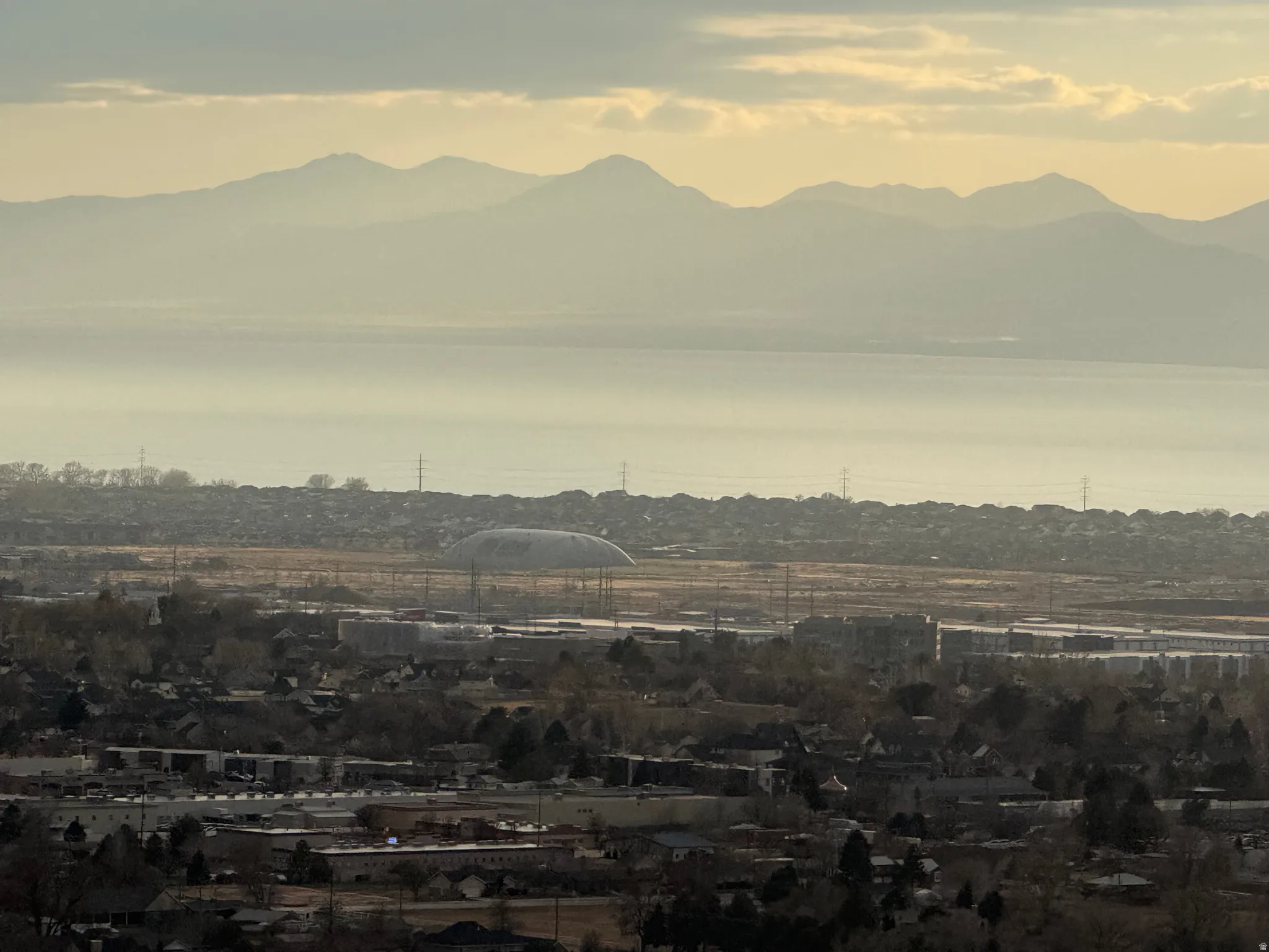Distant mountain range and a large body of water framing a residential and commercial area
