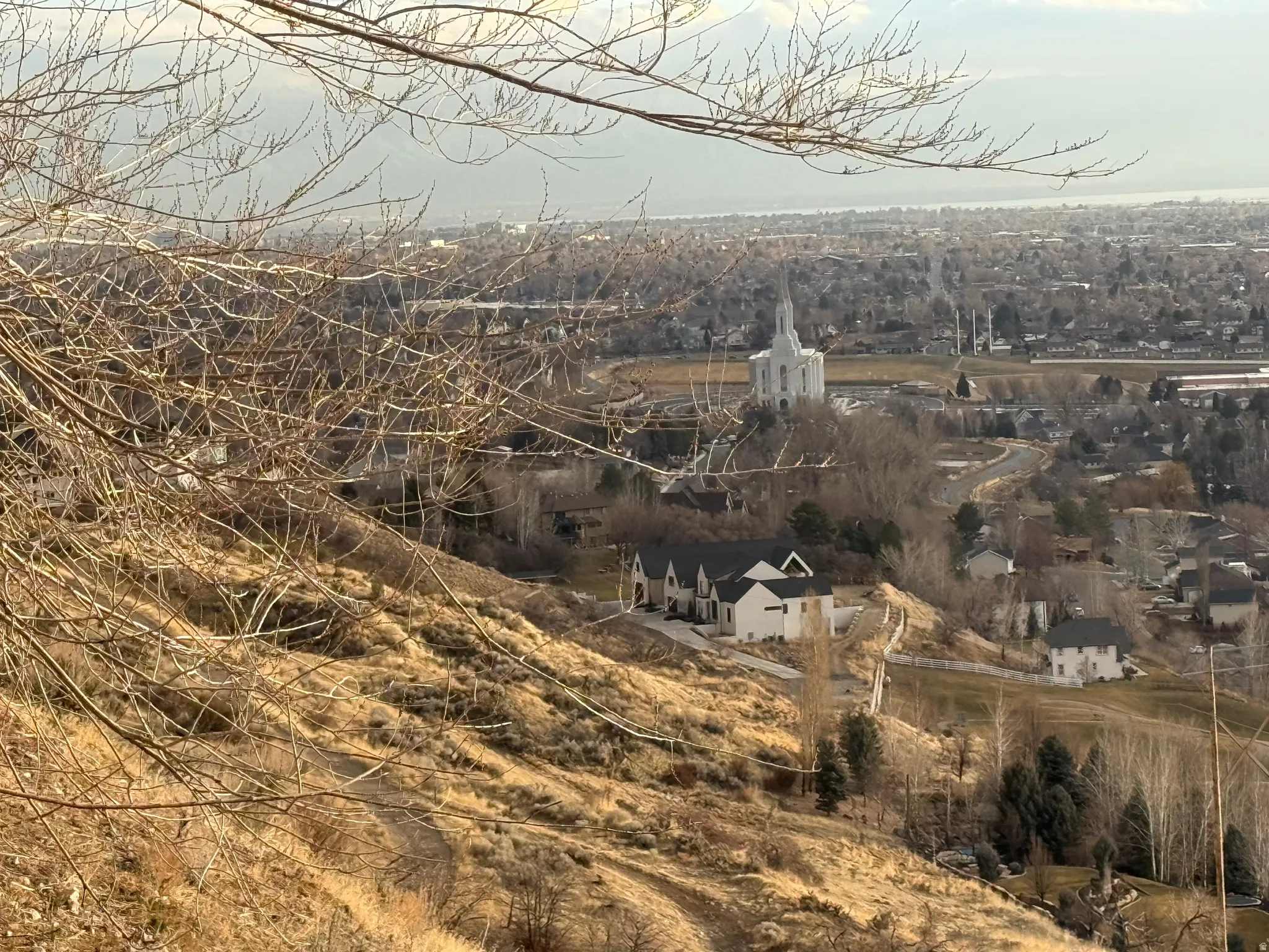 Expansive hillside property with substantial land, offering elevated placement and surrounding residential structures