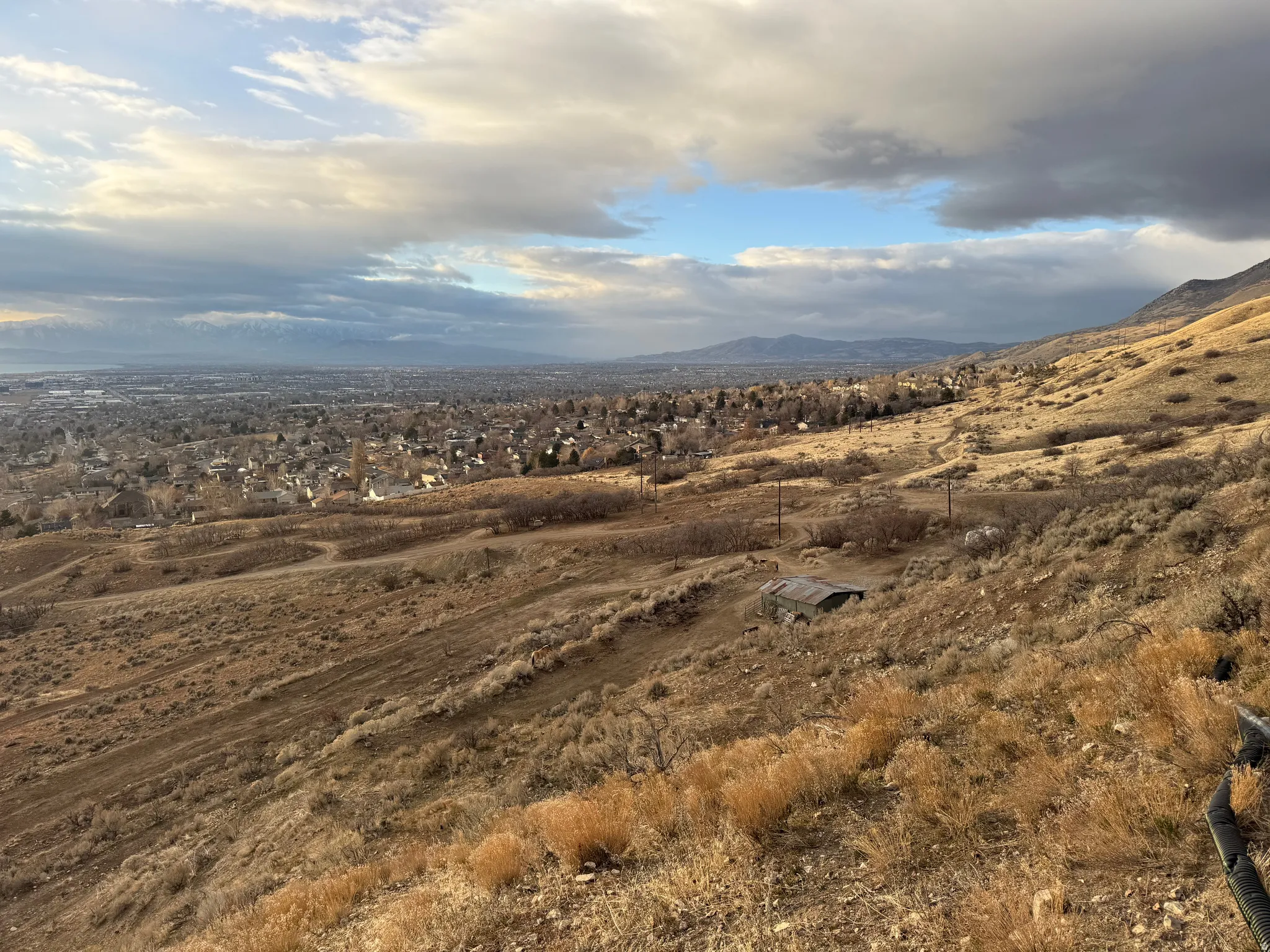 Expansive elevated lot featuring natural terrain and distant urban scenery