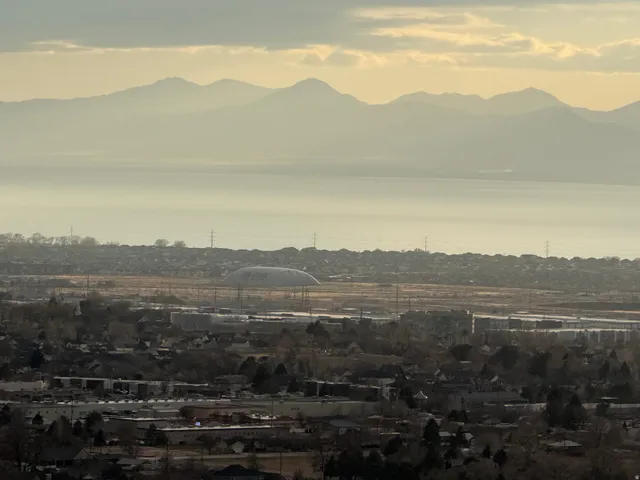 Distant mountain range and a large body of water framing a residential and commercial area