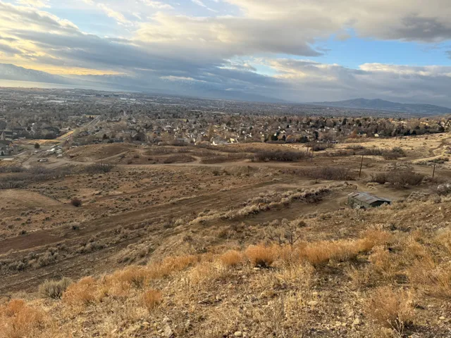 Expansive elevated terrain offering broad scenery of the distant cityscape and mountain ranges