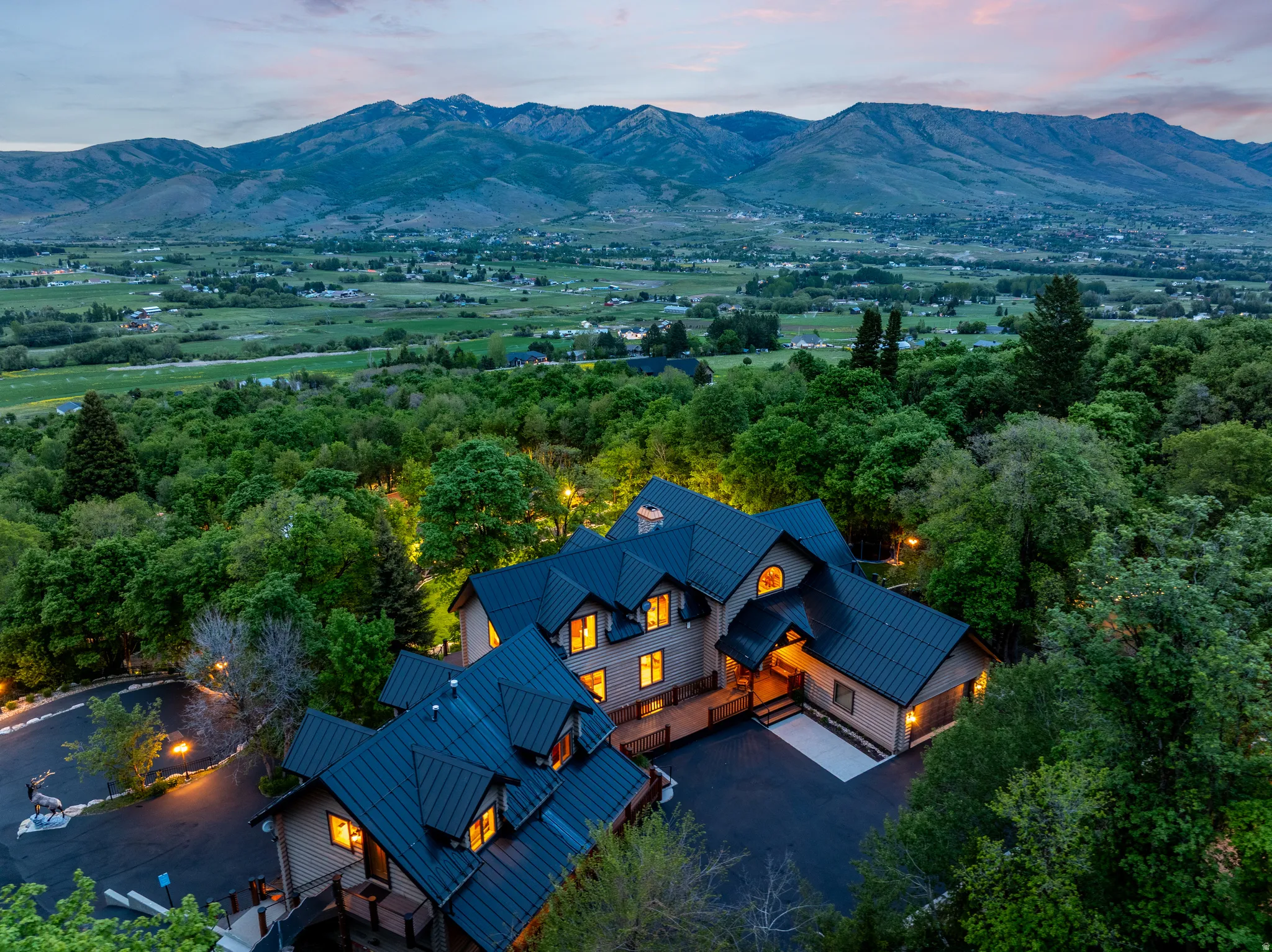 Expansive estate featuring a multi-level architectural design with dark metal roofing