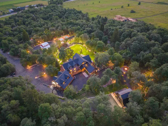 Expansive property featuring a multi-structure estate surrounded by mature trees