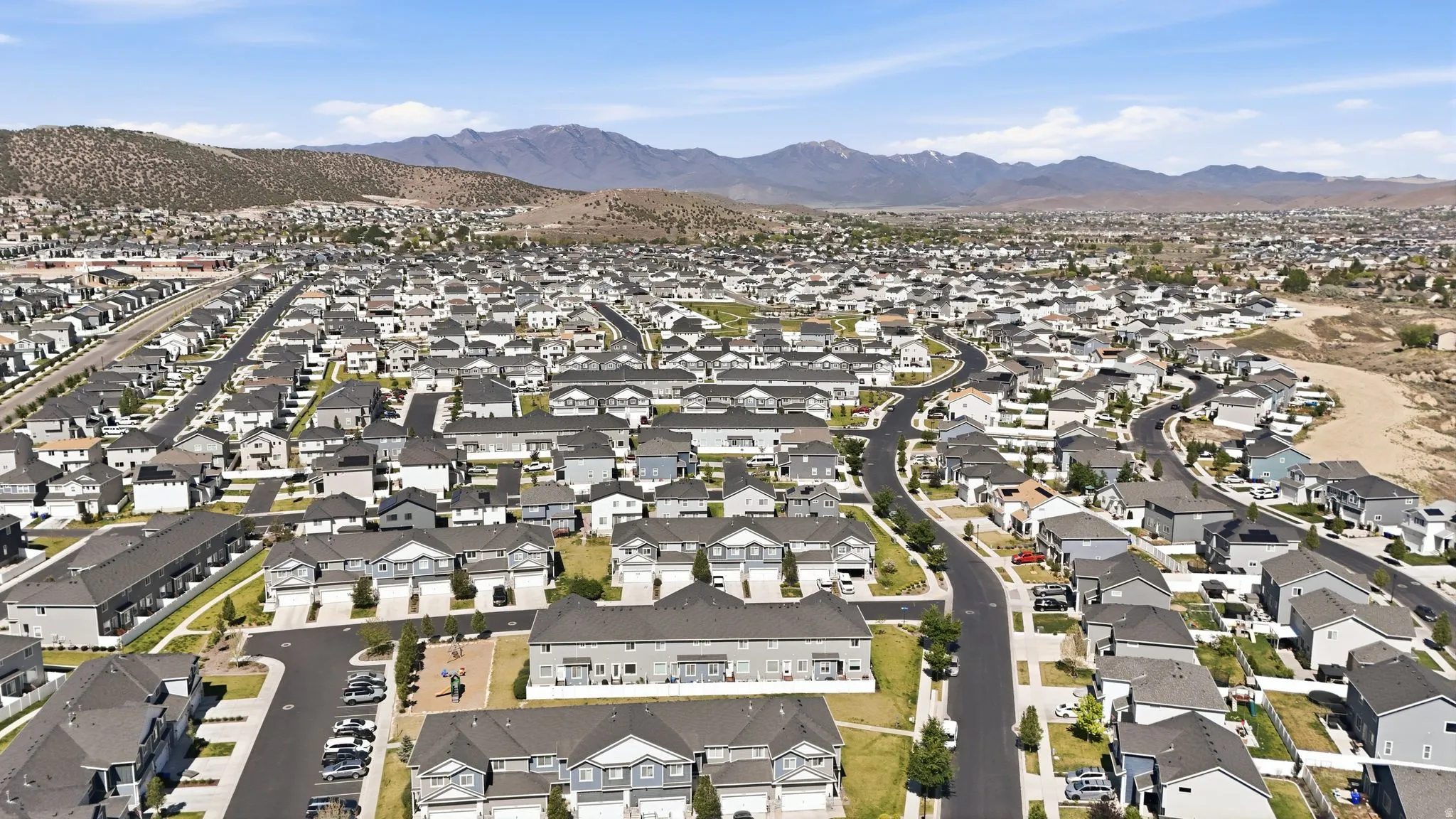 Expansive residential development with a consistent architectural style featuring modern homes with dark roofs