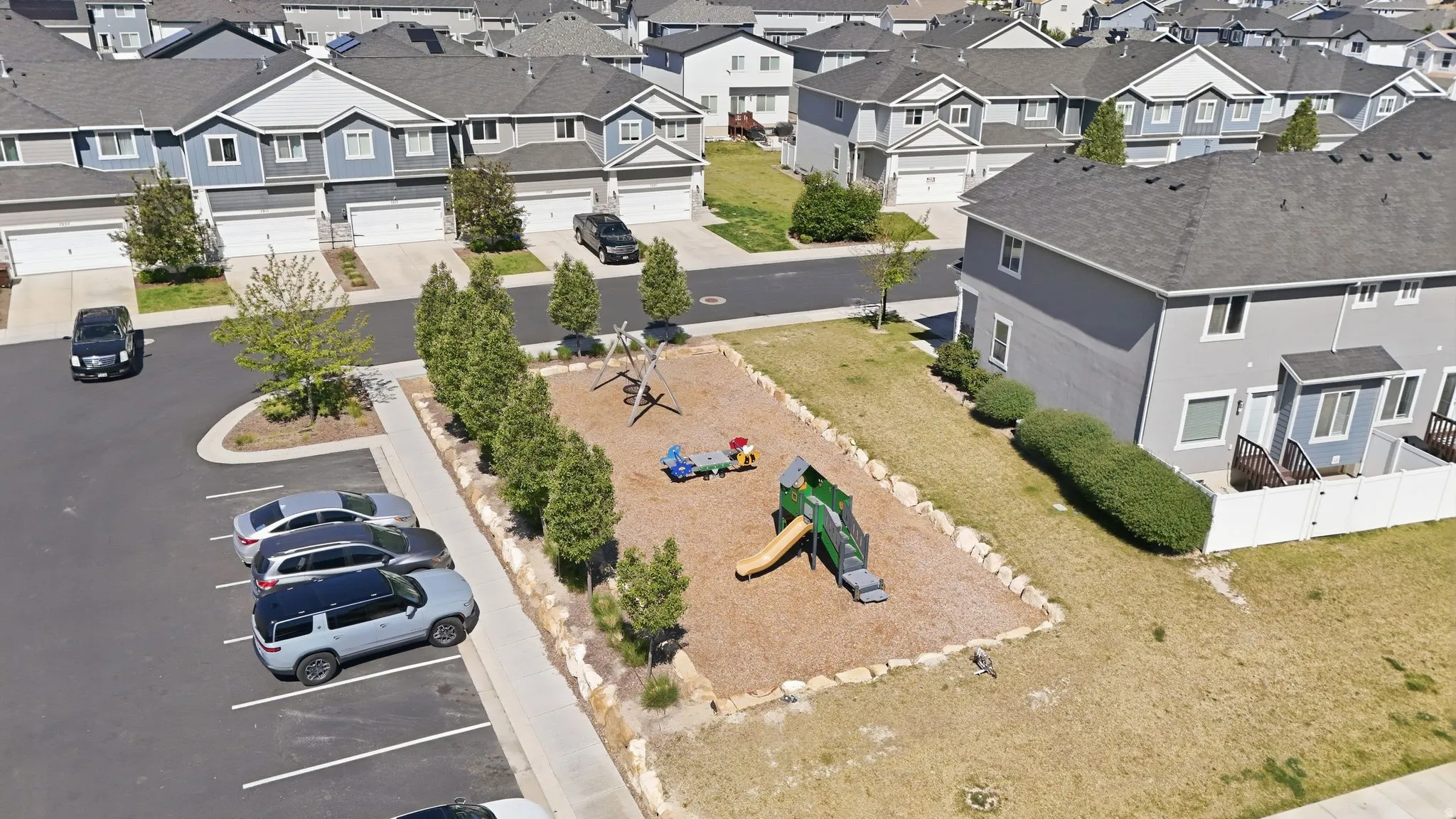 Community playground featuring a slide, swings, and ground-level play equipment