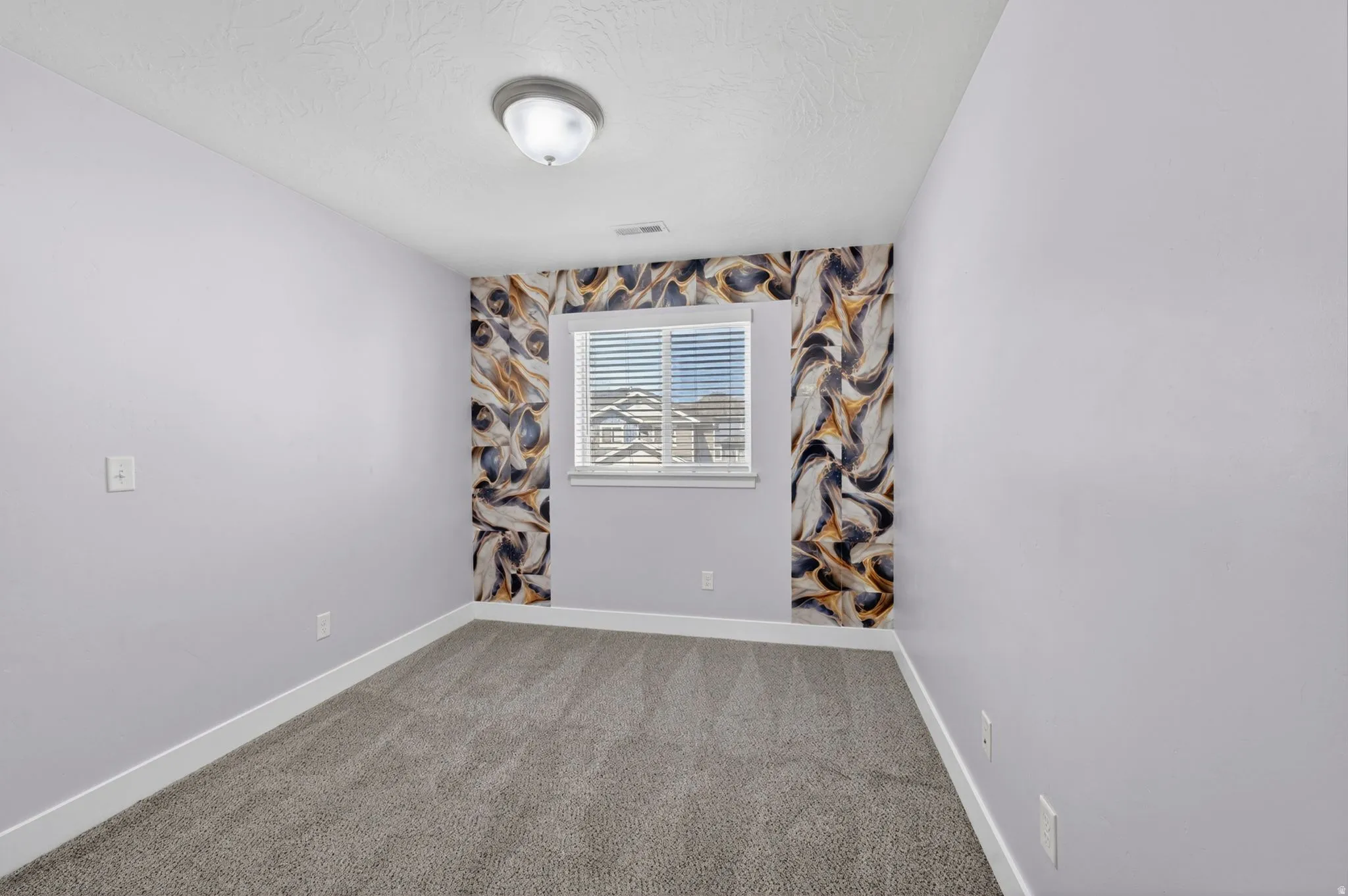 Room featuring gray carpeting, light lavender walls, and white baseboards